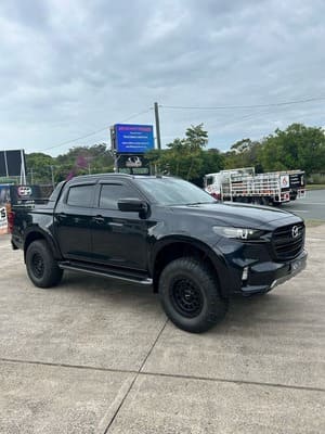  Black Mazda BT-50 dual cab with black ROH wheels and off-road all-terrain tyres.