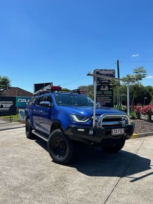  Blue Isuzu D-MAX with front bull bar, aerial mounts, black steel wheels and off-road tyres.