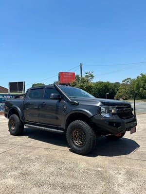  Black Ford Ranger Raptor dual cab with snorkel, aftermarket bull bar, lift kit, bronze Fuel wheels and Falken Wildpeak AT tyres.