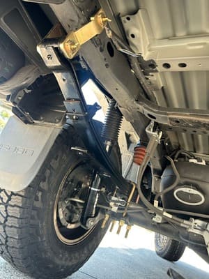  Underbody view of rear suspension upgrade with leaf springs and shocks.
