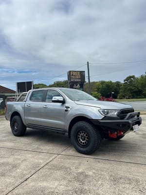  Silver Ford Ranger with aftermarket bull bar, red recovery points and bronze ROH wheels and Falken Wildpeak AT tyres.