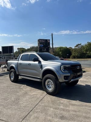  Silver Ford Ranger Next Gen lifted on silver KMC beadlock-style wheels with Falken Wildpeak tyres.