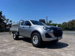  Silver Isuzu D-MAX tray back with off-road tyres and alloy wheels.
