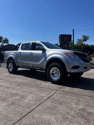  Silver Mazda BT-50 dual cab with lift kit and off-road wheels.