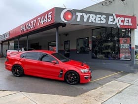  Red Holden Commodore HSV with black performance wheels outside Tyres Excel.